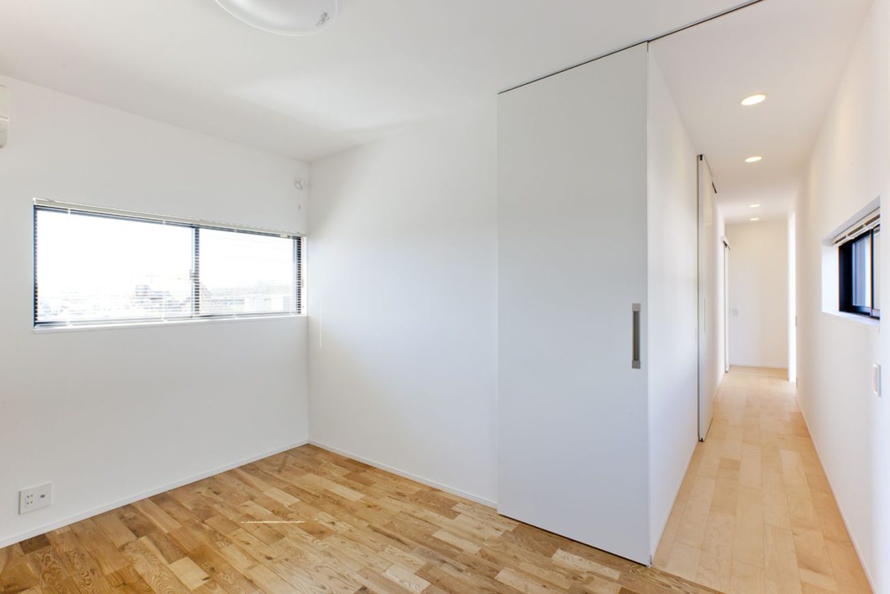 スリット窓にブラインドを取り付けたプライバシー性の高いシンプルな廊下・デザイン住宅