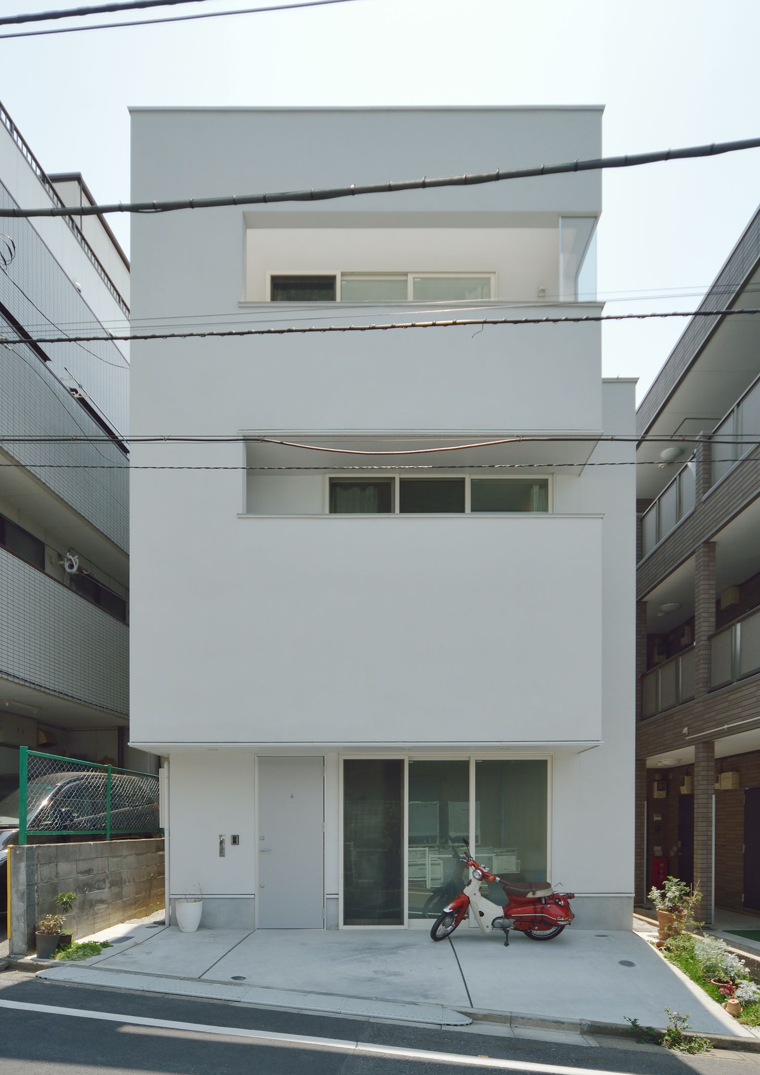 白い外壁のキューブ状の三階建て住宅・デザイン住宅