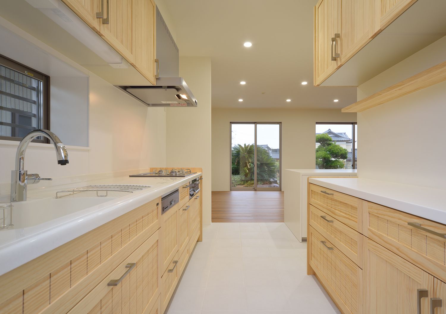 木の収納扉を取り付けた統一感がある半個室型のキッチン・デザイン住宅