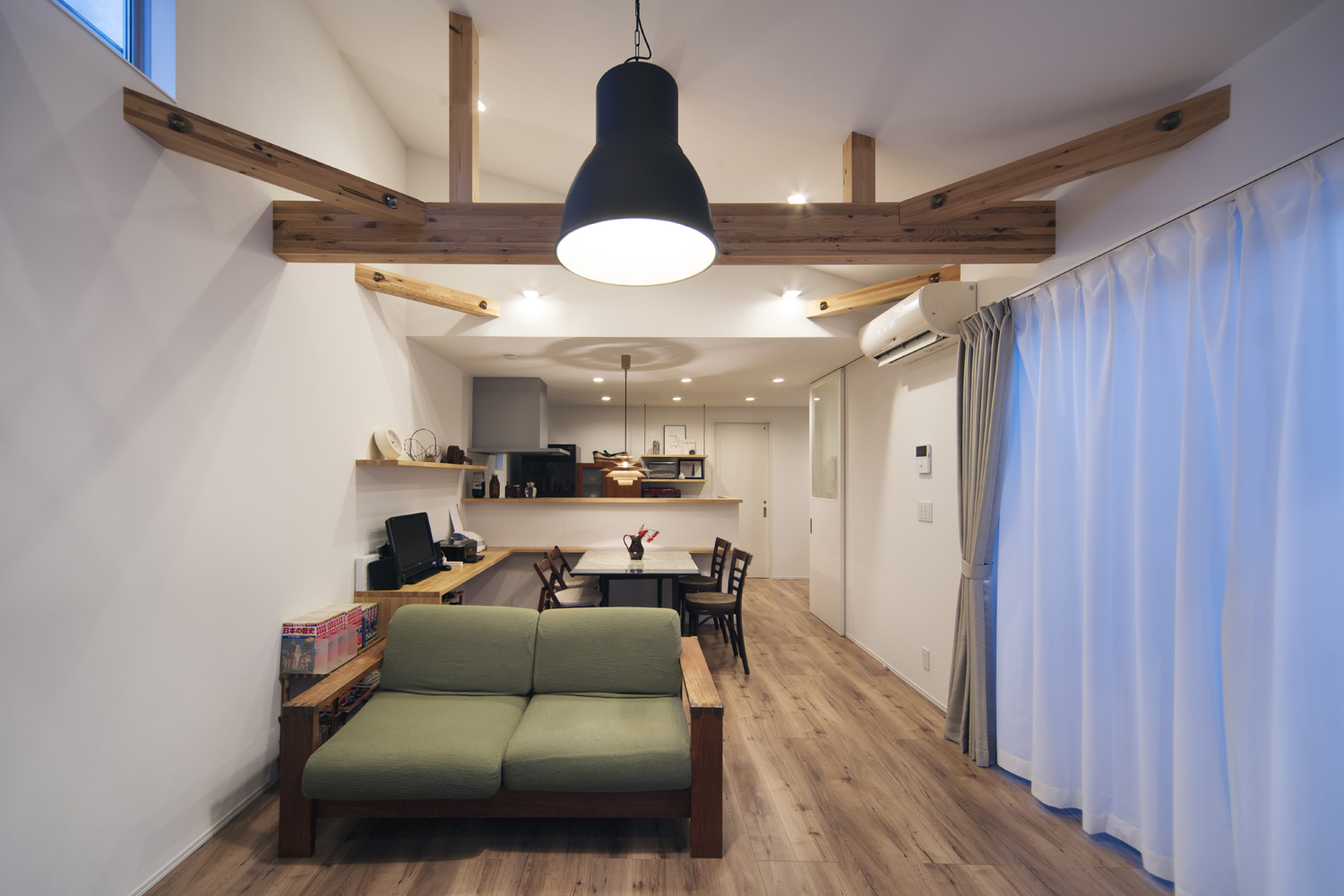 ペンダントライトや、壁に取り付けられたスポットライトに照らされる梁見せ天井のLDK・デザイン住宅 注文住宅・デザイン住宅建築実例_『CASE640 nature』_LDK