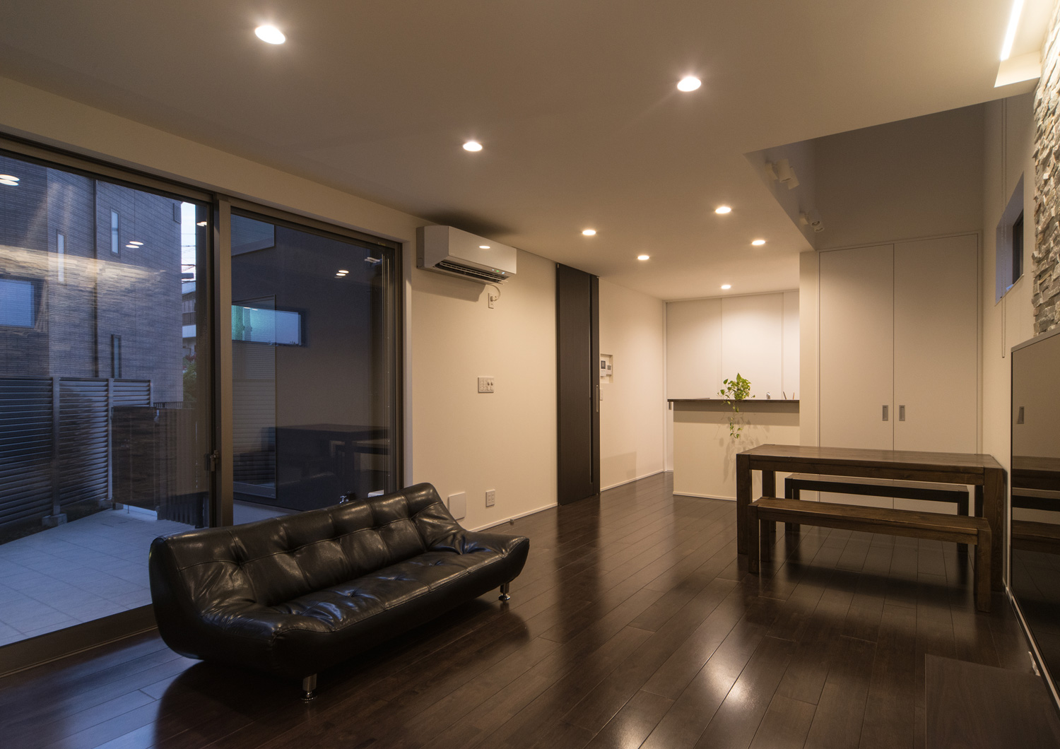 天井にダウンライトが取り付けられた濃い色のフローリングのLDK・デザイン住宅 注文住宅・デザイン住宅建築実例_『CASE652 2つの吹抜けを持つ家。』_LDK