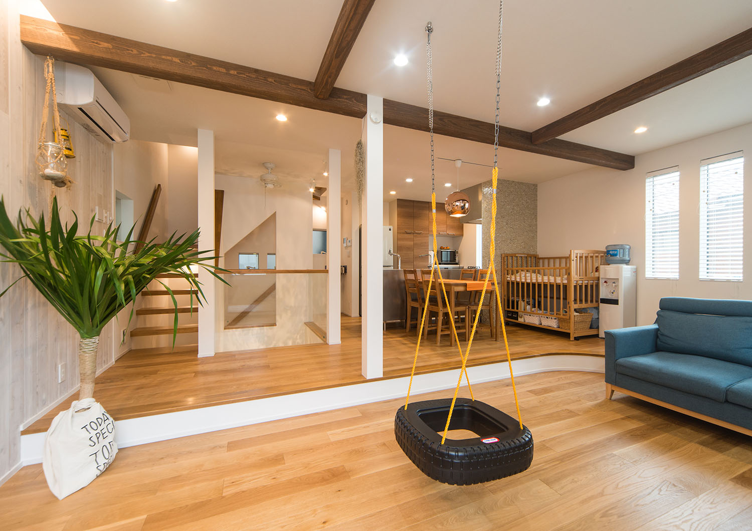 梁見せ天井になっている、タイヤのブランコや観葉植物があるLDK・Gardenのある家 注文住宅・デザイン住宅建築実例_『CASE674 Gardenのある家』_LDK