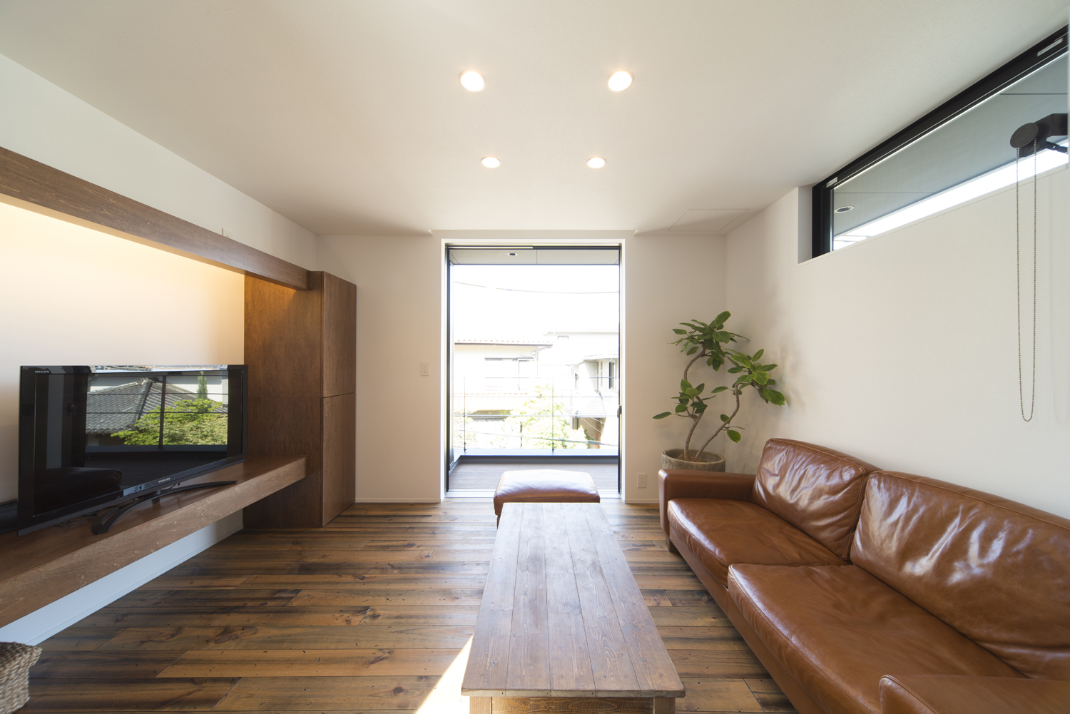 バルコニーに面した大きな窓から光が入るアンティーク調のLDK・デザイン住宅