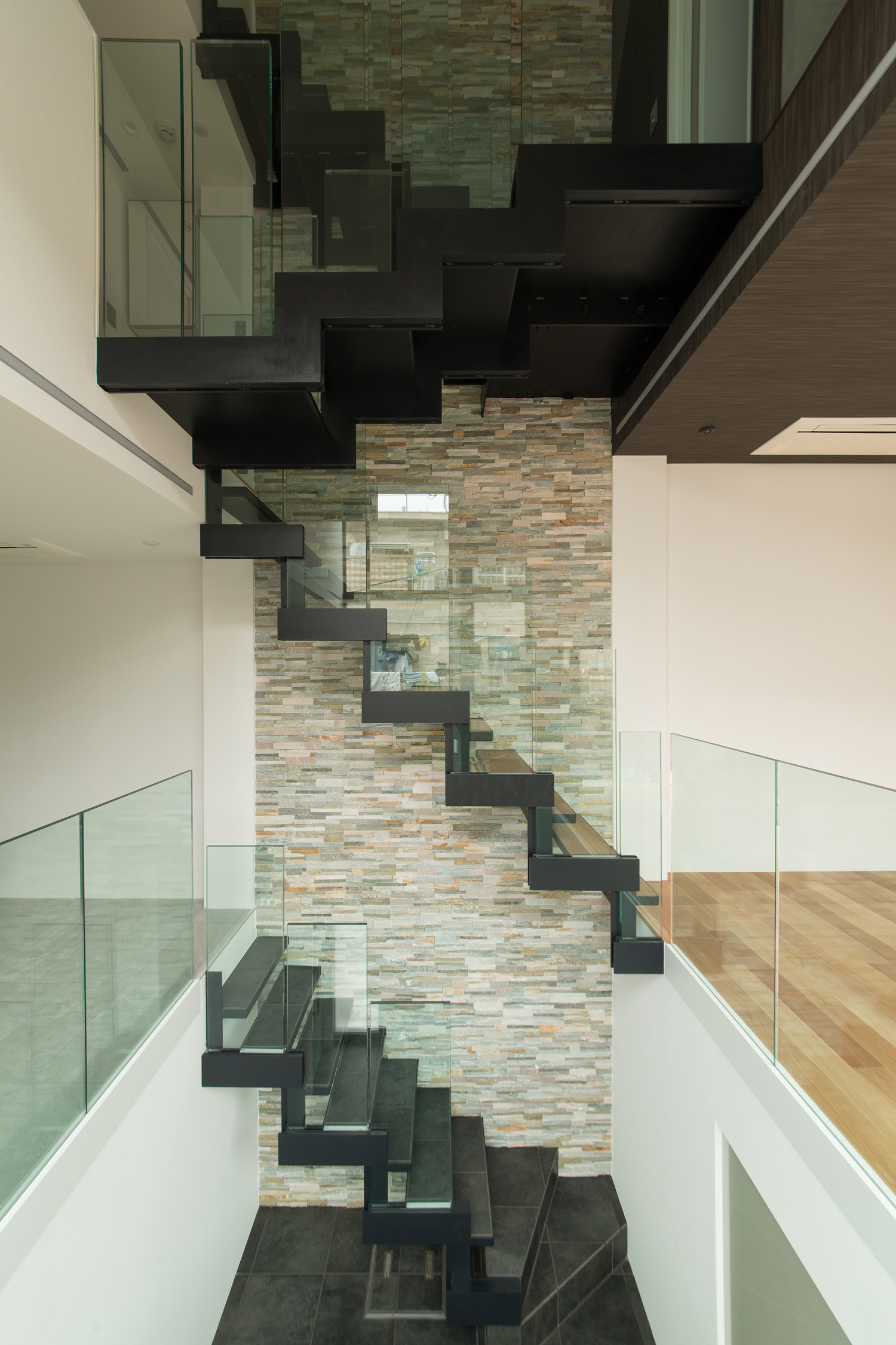 タイルのアクセントウォールにウォルナットのスケルトン階段がある階段室・デザイン住宅 注文住宅・デザイン住宅建築実例_『CASE518 The Residence』_階段