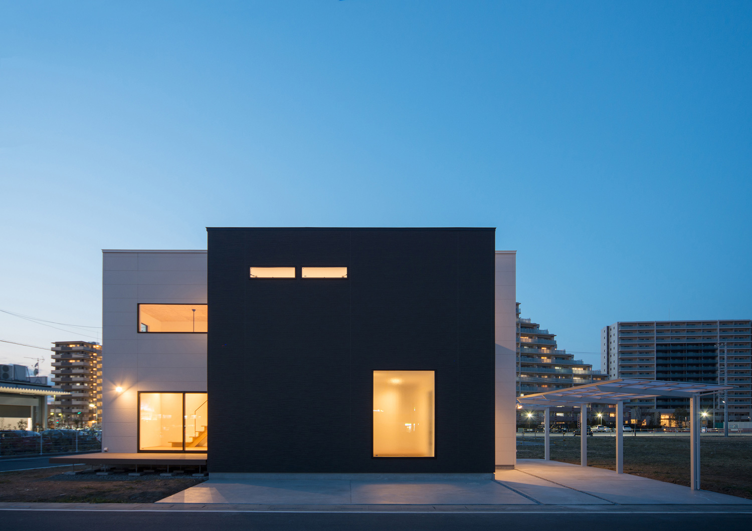 窓から光が漏れる、スクエアな外観の家・デザイン住宅 注文住宅・デザイン住宅建築実例_『CASE526 Two-tone』_外観