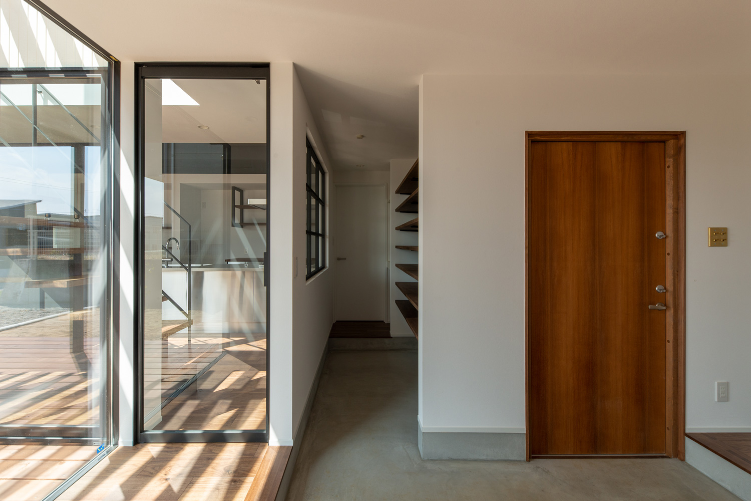 回遊式のシューズインクローゼットがあるモルタルの玄関・デザイン住宅 注文住宅・デザイン住宅建築実例_『CASE609 パーゴラの家』_玄関