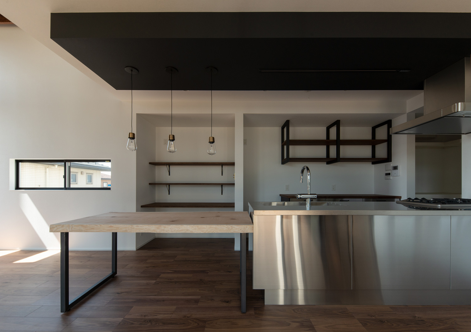 ステンレスのペニンシュラキッチンと木の一枚板のダイニングテーブルが横並びになったLDK・デザイン住宅 注文住宅・デザイン住宅建築実例_『CASE609 パーゴラの家』_LDK