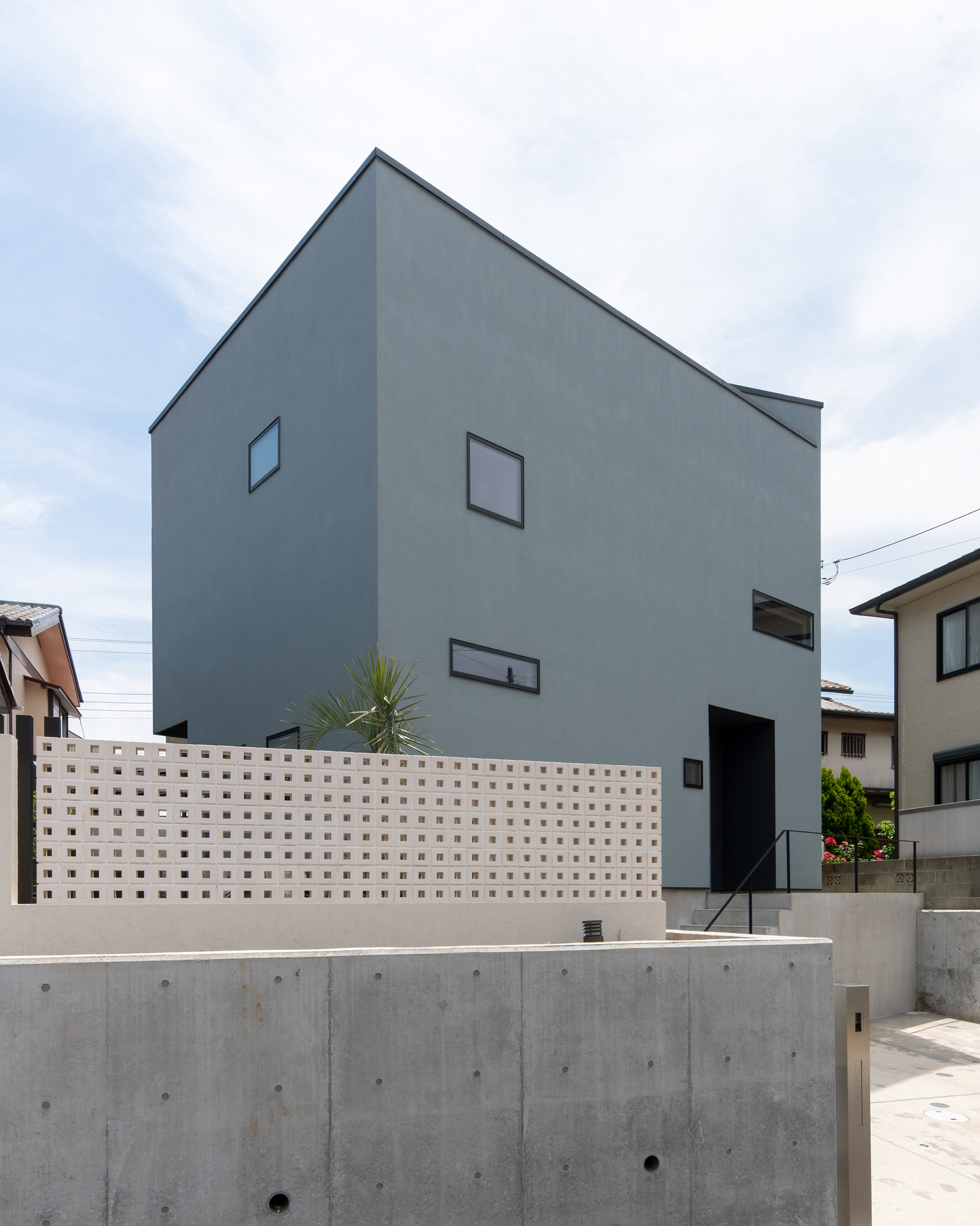 グレーの外壁に小さい窓がついた住宅を斜めから見た様子・デザイン住宅 注文住宅・デザイン住宅建築実例_『CASE621 対角線上の家』_外観