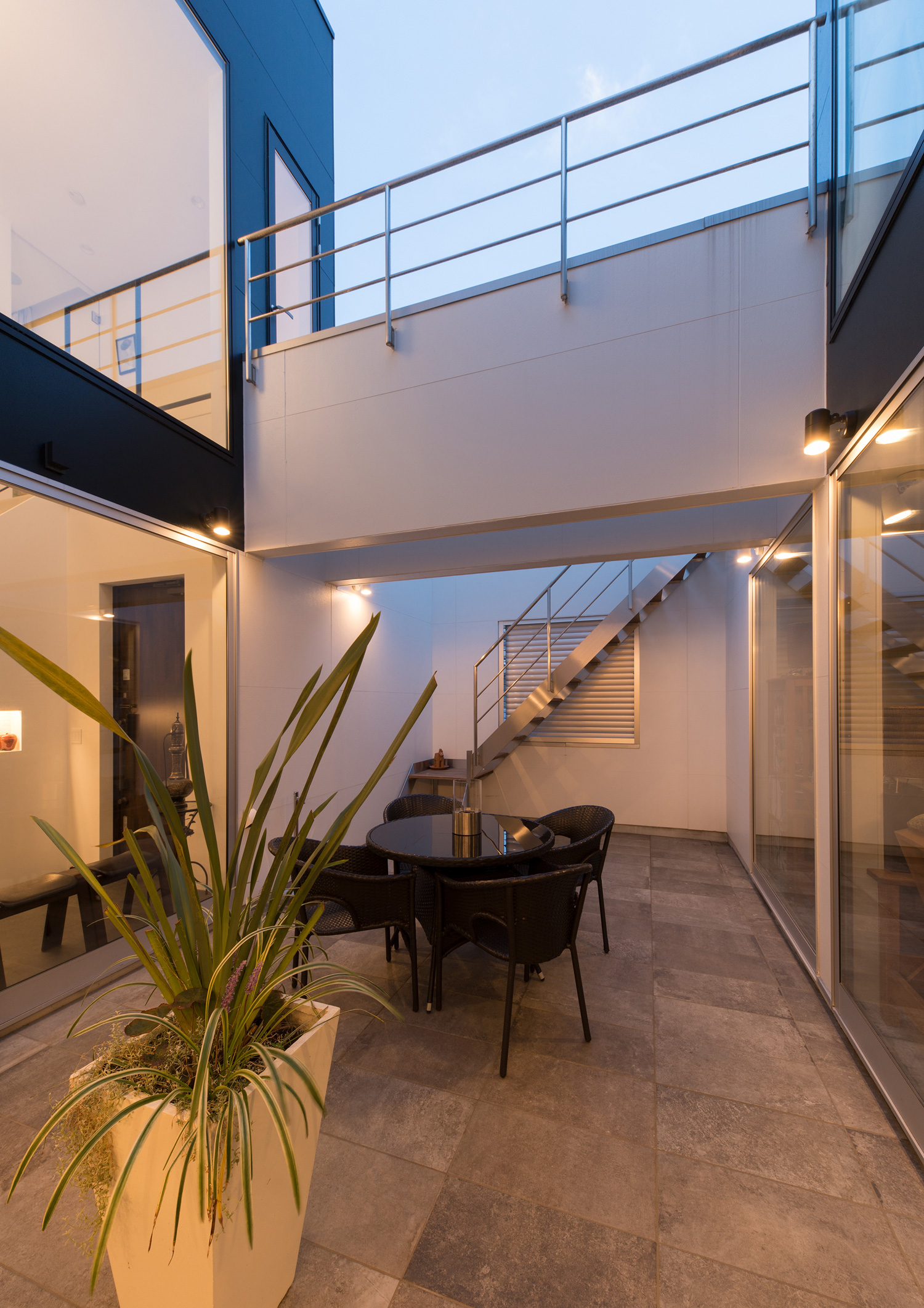 壁にスポットライトが取り付けられた渡り廊下のある中庭・デザイン住宅 注文住宅・デザイン住宅建築実例_『CASE593 CAMP』_中庭