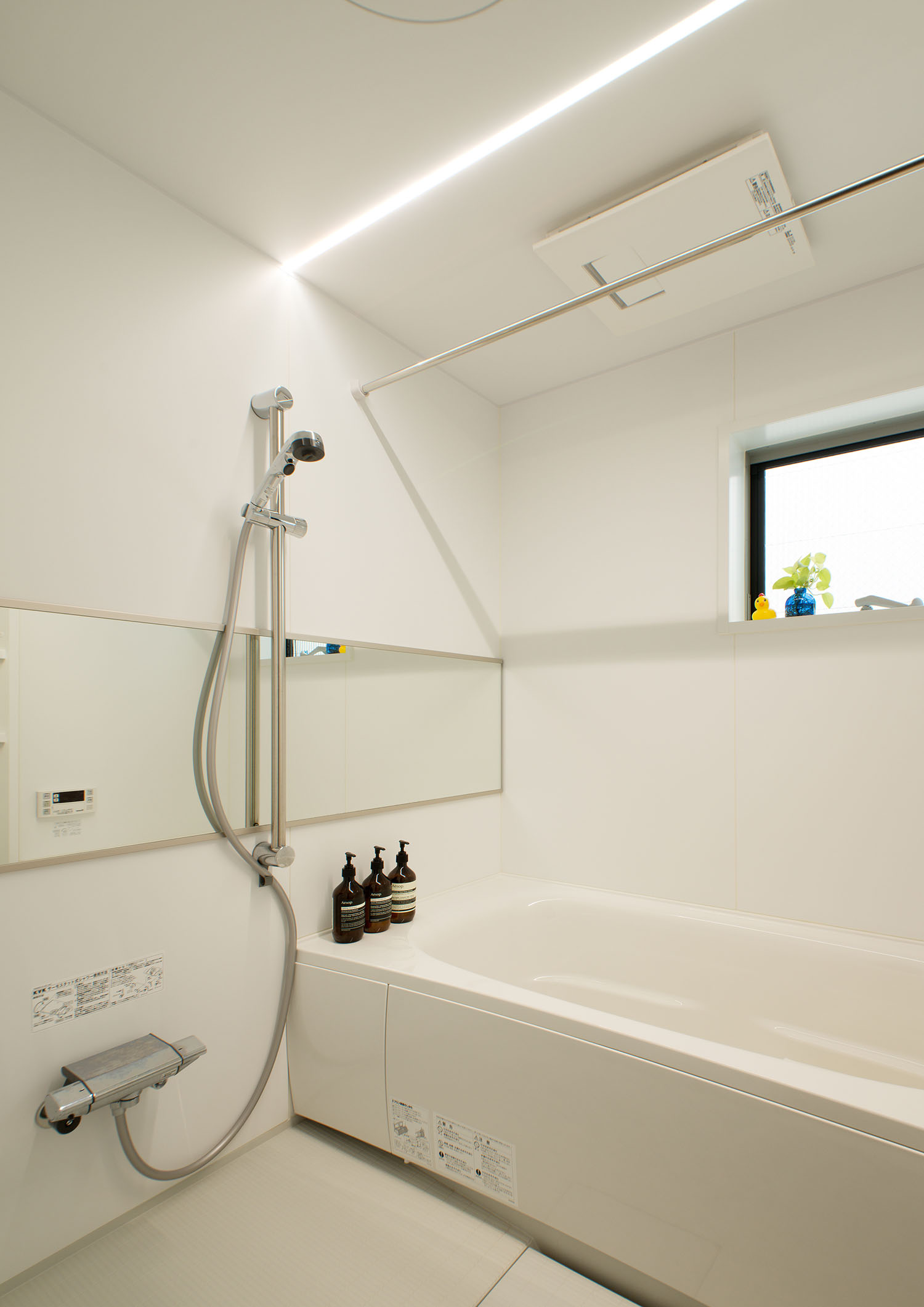 天井にライン照明が取り付けられた白い浴室・デザイン住宅 注文住宅・デザイン住宅建築実例_『CASE487 立方の家』_浴室・洗面所