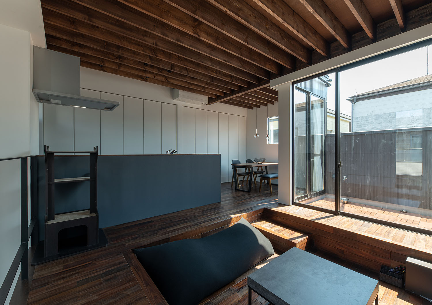 濃い色の木材で統一された中にグレーのインテリアが置かれたLDK・デザイン住宅 注文住宅・デザイン住宅建築実例_『CASE687  "□×□×和 （ハコニワ）"』_LDK