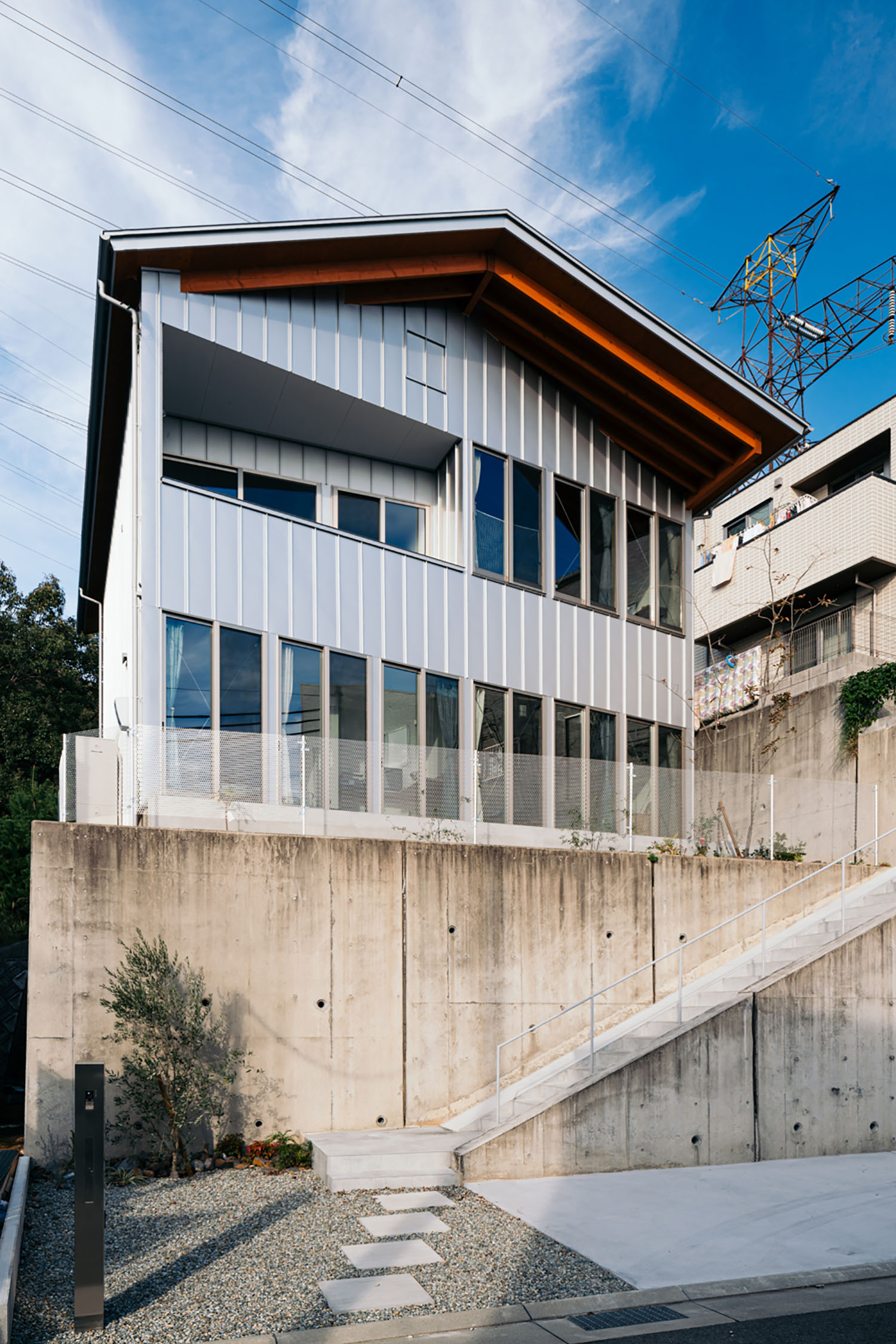 高台の上にあるシルバーの外観の住宅・デザイン住宅 注文住宅・デザイン住宅建築実例_『CASE692 桜ヶ丘の住宅』_外観
