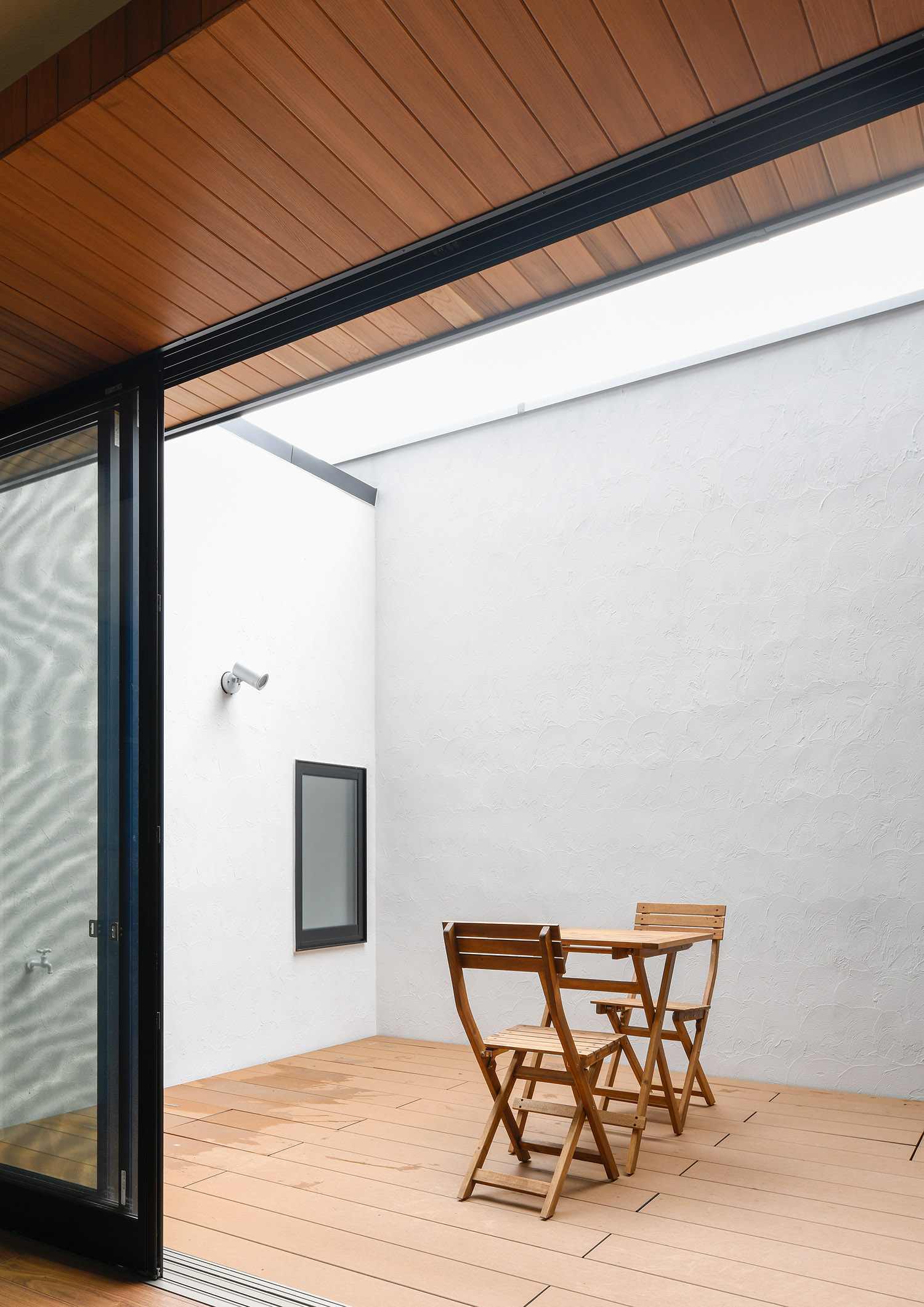 木の椅子とテーブルが置かれたウッドデッキの中庭・デザイン住宅 注文住宅・デザイン住宅建築実例_『CASE751 Contarst』_中庭