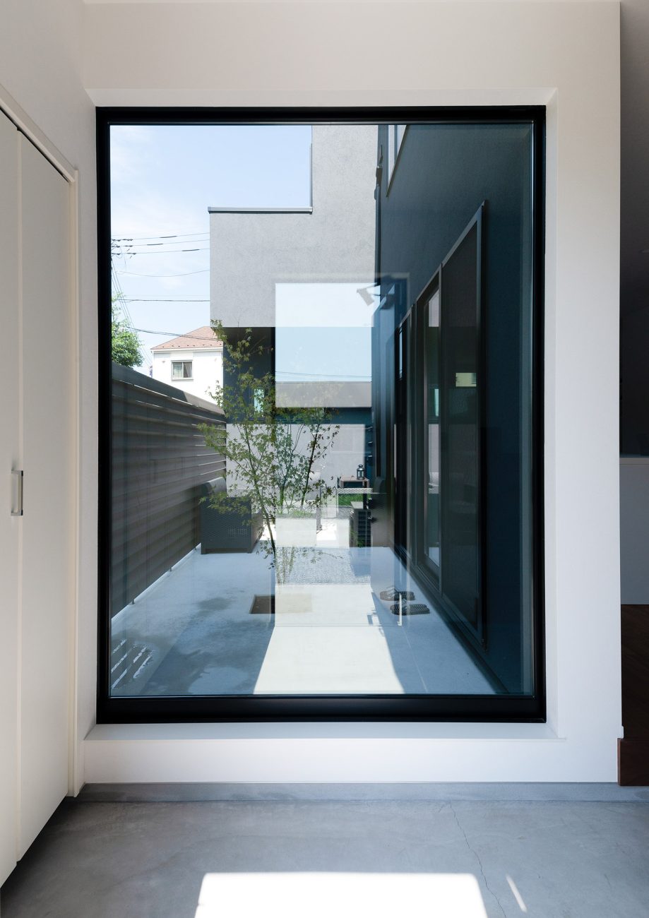 大きな窓から植栽が見える土間玄関・デザイン住宅 注文住宅・デザイン住宅建築実例_『CASE763 ソト黒ウチ白』_玄関