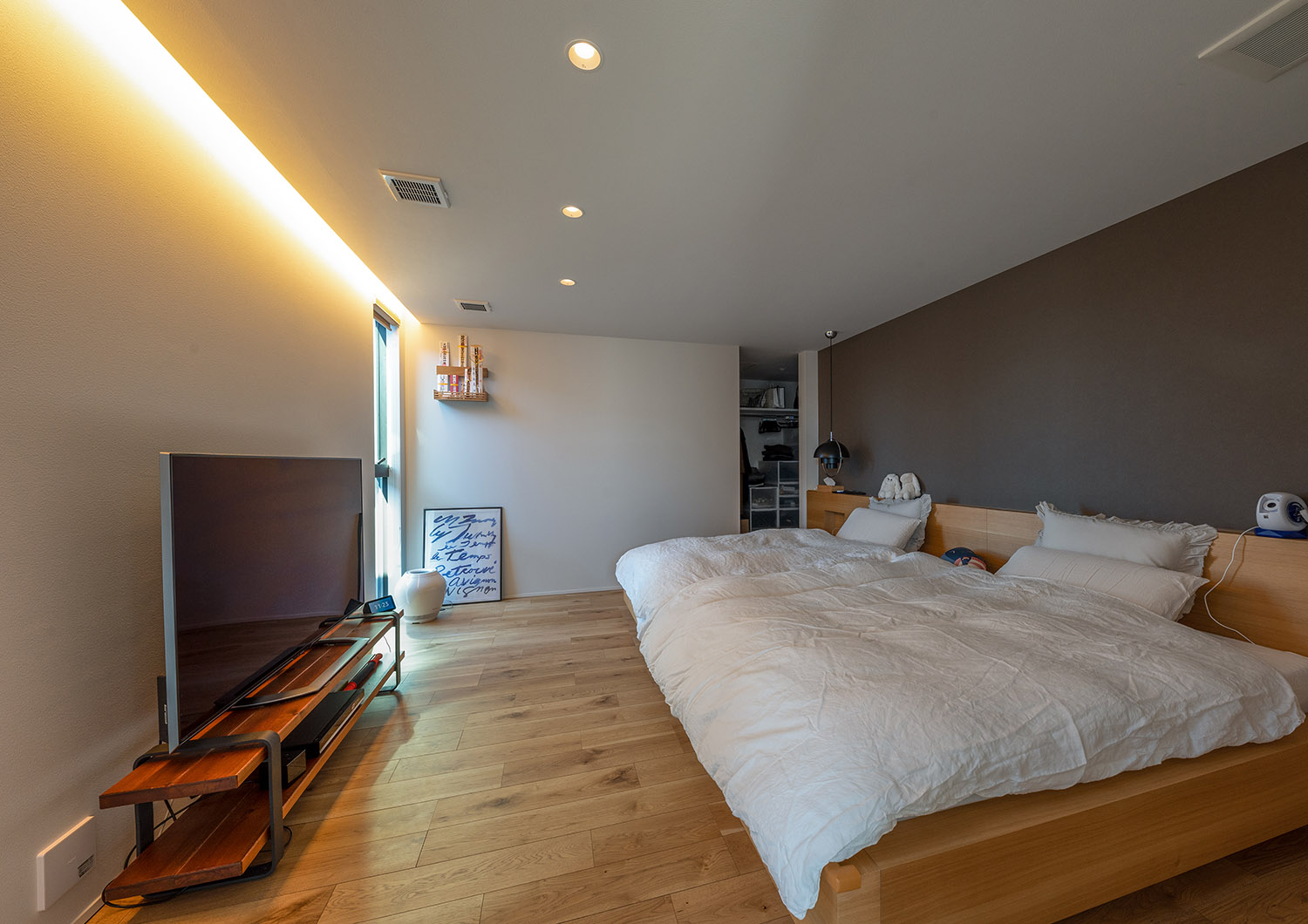 壁際に間接照明を取り付けたテレビのあるホテルライクな寝室・デザイン住宅 注文住宅・デザイン住宅建築実例_『CASE771 VOIDS』_寝室