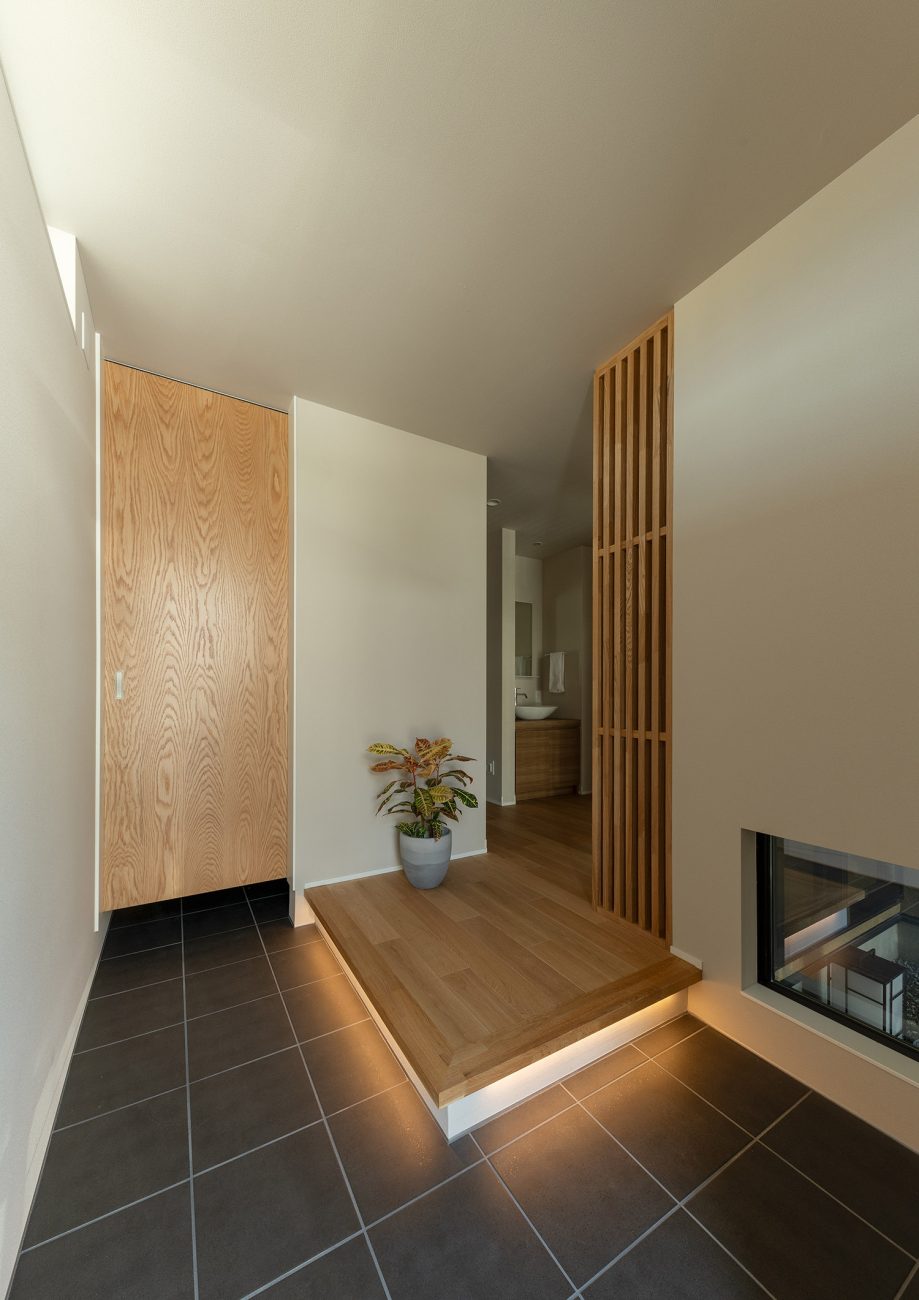 黒のタイル床で足元に間接照明を取り付けた和モダンな玄関・デザイン住宅 注文住宅・デザイン住宅建築実例_『CASE774 和/紙の温もり』_玄関